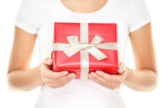 Gift / Christmas present. Woman showing and givng red gift with ribbon. Closeup of isolated on white background.