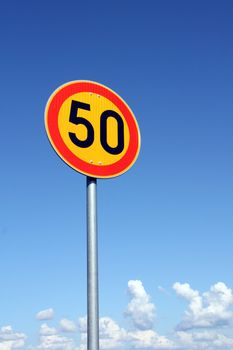 Maximum Speed 50 km per hour with bright sky background