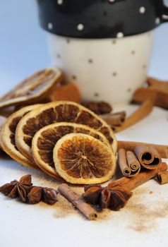 Tea, cinnamon sticks, dry orange and cups