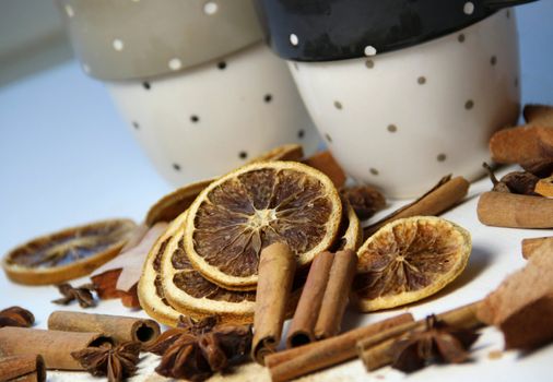 Tea, cinnamon sticks, dry orange and cups
