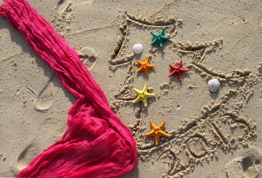 Funny beach Christmas tree decorated with the sea stars and shells