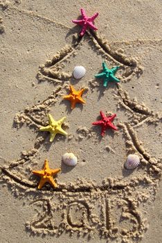 Funny beach Christmas tree decorated with the sea stars and shells