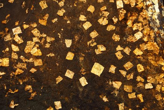 Close up gold leaves attached on the buddha statue, Ayutthaya, Thailand
