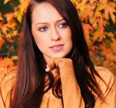 Beautiful elegant woman in autumn park