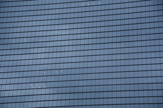 Closeup of a skyscraper glass facade background pattern