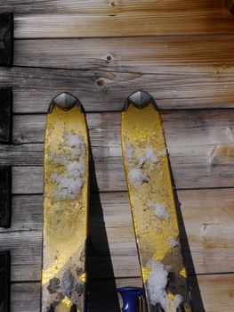 Image of skis leaning on a wooden wall