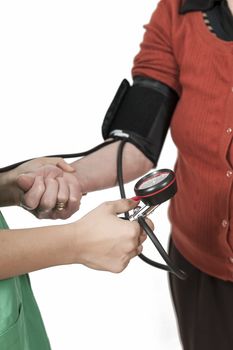 Doctor taking old lady's blood pressure on white background