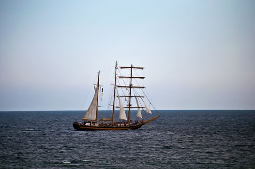 Old sailing ship in the sea .