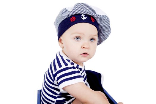 cute little baby in sailor fashion playing isolated on white background