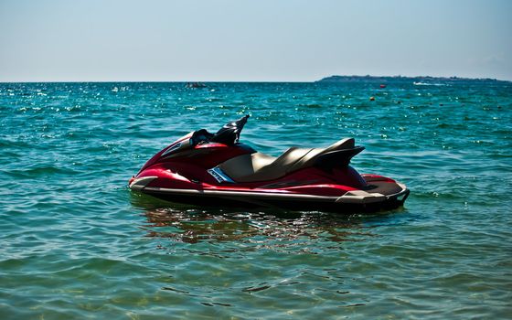 Red jet ski in the sea .