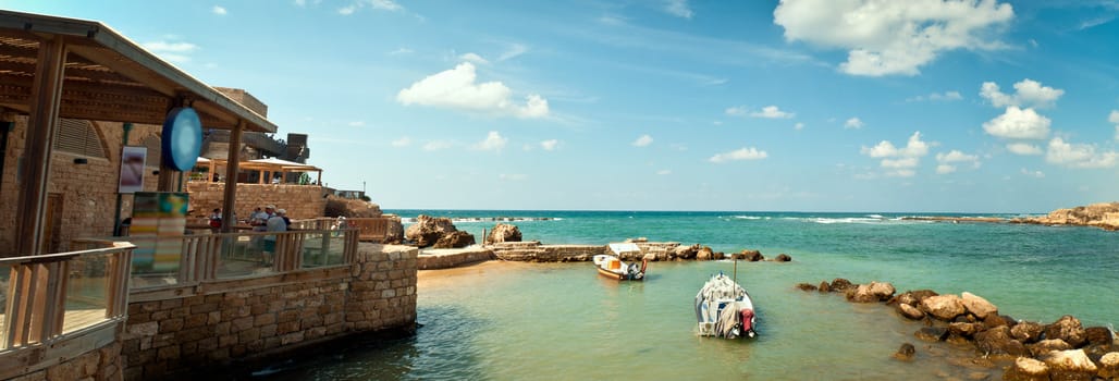 Old port of Caesarea in Israel with crystal clear water Historical landmark .