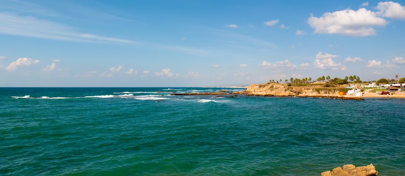 Old port of Caesarea in Israel with crystal clear water Historical landmark .