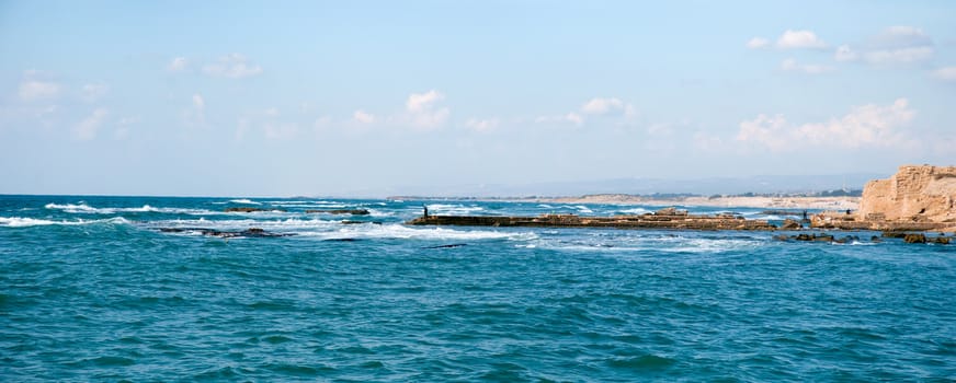 Old port of Caesarea in Israel with crystal clear water Historical landmark .