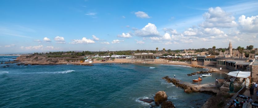 Old port of Caesarea in Israel with crystal clear water Historical landmark .