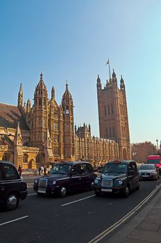 Westminster - Houses of Parliament in London and london's iconic black cabs are a symbol of the city.