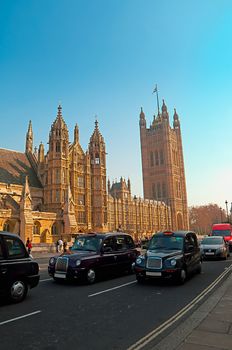 Westminster - Houses of Parliament in London and london's iconic black cabs are a symbol of the city.