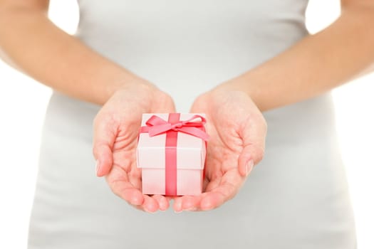 Hands holding gift / present in isolated on white background. Closeup of Female hands giving the gift.