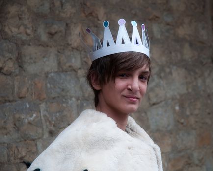 Boy dressed in a robe of King.
