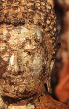 Close up buddha statue covered with gold leaves at Wat Yai Chai Mongkhol, Ayutthaya, Thailand