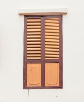 Old wooden window on plain concrete wall