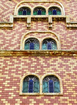 Brick wall and aged windows of castle