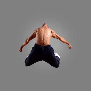 dancer jumping on a gray background, having a fun