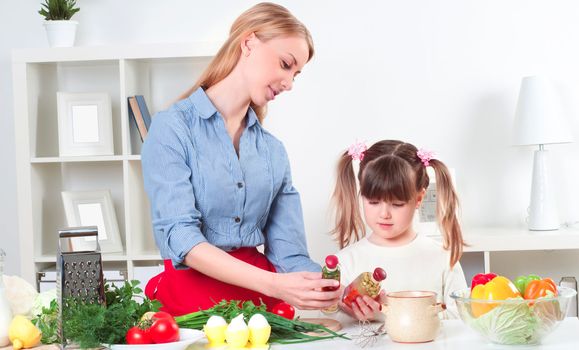 Mother and daughter cooking together, help children to parents