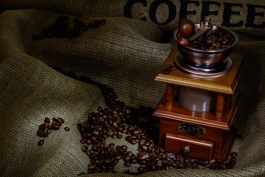 Coffee Mill with beans and burlap. still life