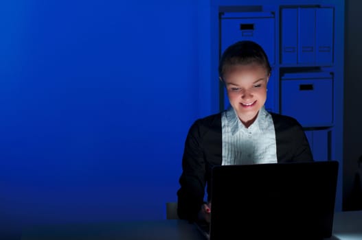 portrait of a woman in a night office, working all night