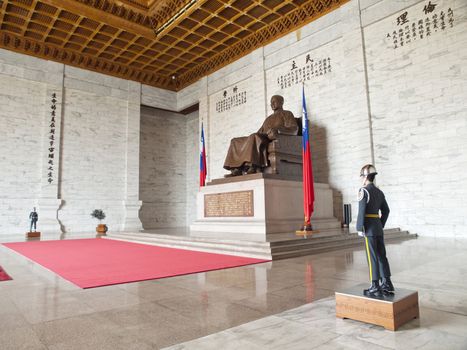 TAIPEI, TAIWAN - APRIL 29: A large bronze statue of Chiang Kai-shek on April 29, 2010 in Taipei, Taiwan. This huge bronze statue is shown smiling, seated and wearing traditional Chinese dress of Chiang Kai-shek dominates the main hall of the CKS memorial hall.