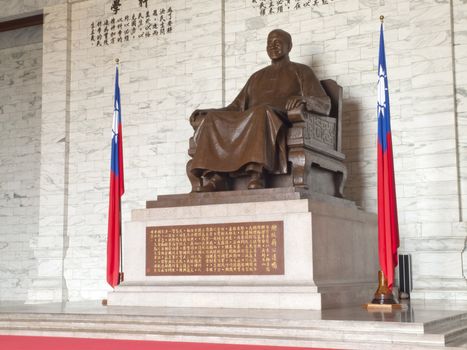 TAIPEI, TAIWAN - APRIL 29: A large bronze statue of Chiang Kai-shek on April 29, 2010 in Taipei, Taiwan. This huge bronze statue is shown smiling, seated and wearing traditional Chinese dress of Chiang Kai-shek dominates the main hall of the CKS memorial hall.