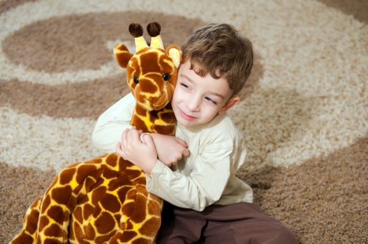 Beautiful little boy with toys  .