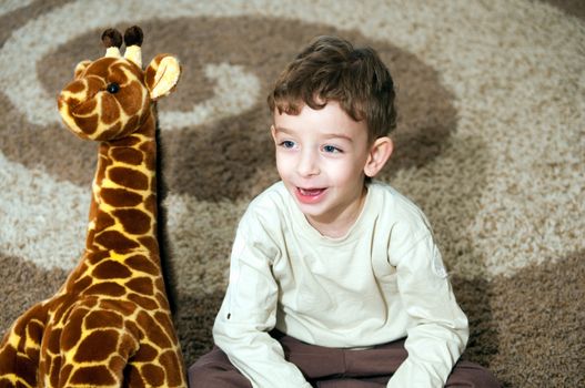 Beautiful little boy with toys  .