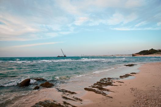 Mediterranean coast  with ships and parachute flying above the sea .