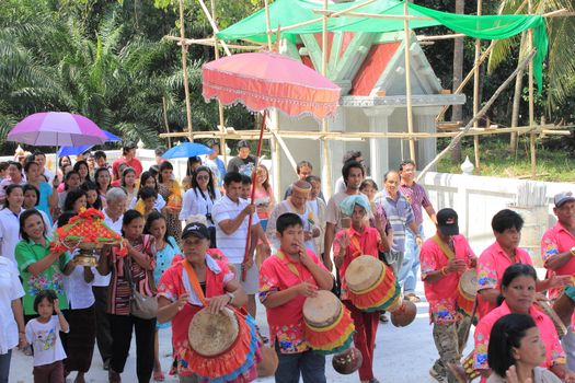 NAKON SI THAMMARAT, THAILAND - NOVEMBER 17 : Unidentified Thai people circle the temple 3 times with offering Buddhist ordination ceremony on November 17, 2012 in Nakon Si Thammarat, Thailand.