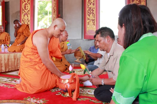 NAKON SI THAMMARAT, THAILAND - NOVEMBER 17 : Newly ordained Buddhist monk  worship parents in Buddhist ordination ceremony on November 17, 2012 in Nakon Si Thammarat, Thailand.