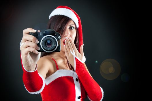 Portrait of Santa Claus surprised girl with Camera
