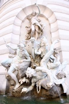 Sculptures on Michaelerplatz Fountain in Hofburg Quarter, Vienna, Austria 