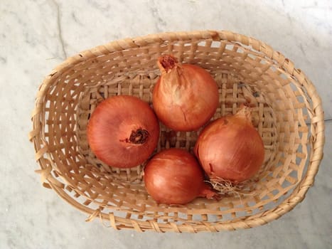 onions in a straw basket