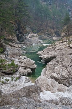 Stream of green color running between rocks