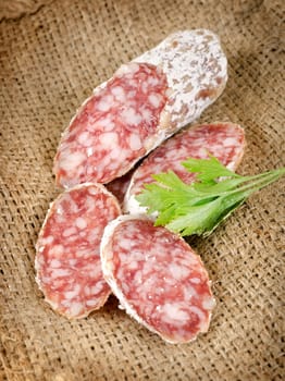 Salami sausage and parsley in the tissue