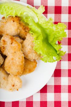 Cutlets and lettuce leaf on a white plate