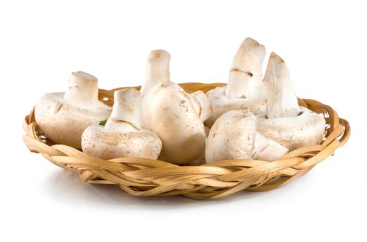 Basket with mushrooms isolated on white background