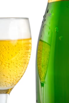 A glass and a bottle of champagne isolated on a white background