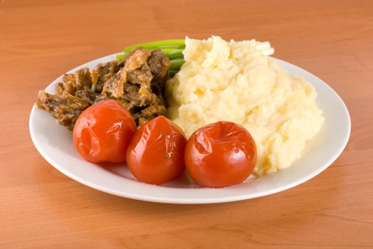 Cooked potatoes with liver and vegetables on the table