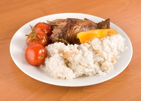 Boiled rice with grilled poultry on the table