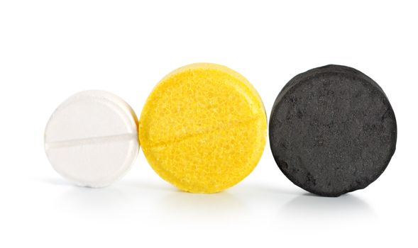 Aspirin, vitamin, coal. Pills isolated on white background