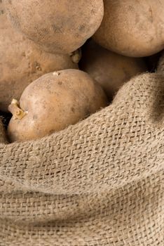 Raw potatoes in an old rag bag