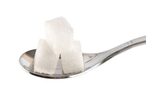 Spoon with sugar cubes isolated on a white background