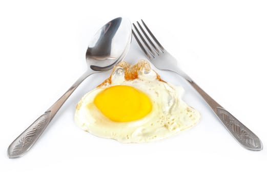 Fried egg with a spoon and fork on white background